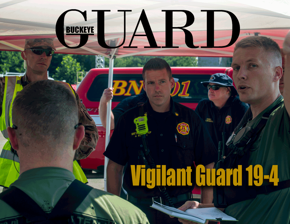Cover of Buckey Guard online publication - Soldiers and EMS gather under tent with EMS vehicles in background.