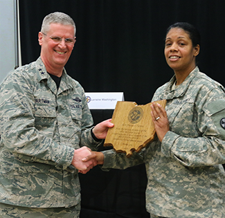 Maj. Gen. Mark E. Bartman (left), Ohio adjutant general, presents a plaque of appreciation to Sgt. Maj. Tanya Turpin, senior supply supervisor, 16th Engineer Brigade.