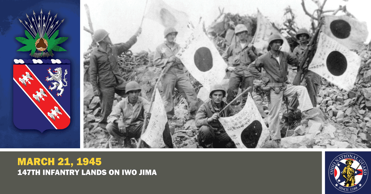 Members of Company A, 147th Infantry, proudly display Japanese flags.