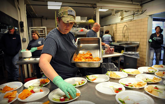 Master Sgt. Kristin Weeman, a first sergeant with the 180th Fighter Wing, prepares food at the Cherry Street Mission Eatery 