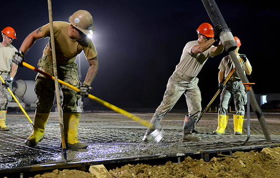 Master Sgt. Joe New, a structures technician with the 200th RED HORSE Squadron, pours concrete for multipurpose building foundations.