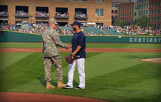 Pfc. Mark Horton (left), Ohio National Guard Soldier of the Year, shakes hands with his former Lakewood St. Edward High School football teammate, current Columbus Clippers catcher Alex Lavisky.