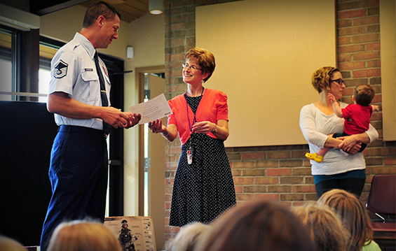Master Sgt. Norman J. Drzewiecki, an information protection manager with the 180th Fighter Wing, receives a certificate of appreciation from Patti Lusher, a librarian at the Waterville Branch Library.