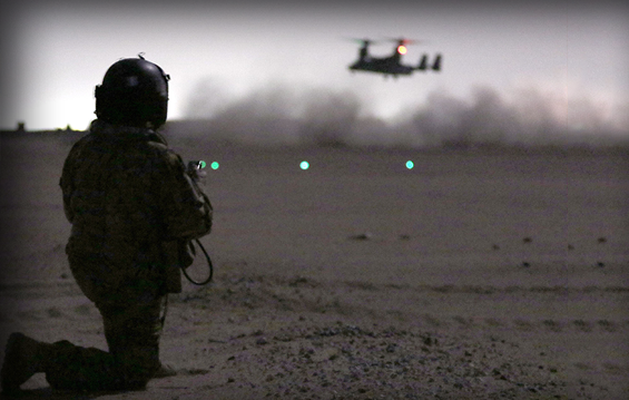 Ohio Army National Guard Chief Warrant Officer 4 David Corbi watches as a Marine Corps MV-22 Osprey lands during a personnel recovery training exercise.