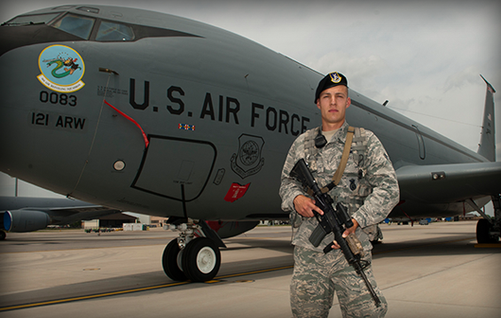 Airman 1st Class Joseph T. Nenadich, a member of the 121st Security Forces Squadron, stands in front of a KC-135 Stratotanker at Rickenbacker Air National Guard Base in Columbus, Ohio.