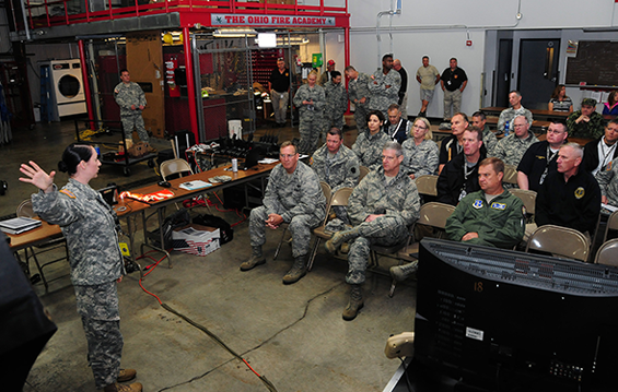 First Lt. Amanda Britton, site support officer, briefs Maj. Gen. Mark E. Bartman, Ohio adjutant general, and other distinguished visitors June 17, 2015, during the Guardian Shield '15 exercise at the Ohio Fire Academy in Reynoldsburg, Ohio.