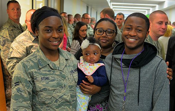 Airman First Class Reyonne Stone stands with Family members after a call to duty ceremony for the 123rd Air Control Squadron.