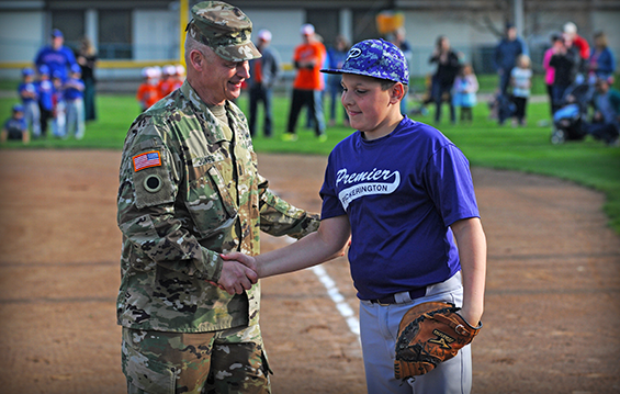 Command Sgt. Maj. Rodger M. Jones, Ohio Army National Guard state command sergeant major, shakes the hand of Jonas Mann of the Pickerington Premier Baseball Team.