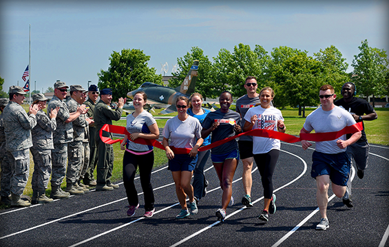 Airmen of the 121st Air Refueling Wing celebrate the opening of a new quarter-mile running track 