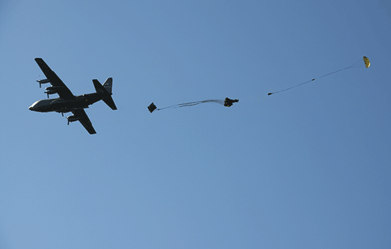 A C-130 Hercules releases cargo during an airdrop exercise