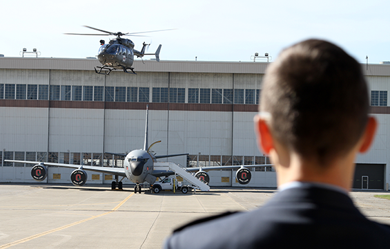 A member of the Serbian Armed Forces delegation watches as a UH-72 Lakota medical helicopter takes flight.