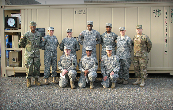 Chief Warrant Officer 4 Charles H. Talley Jr. (left), Philip A. Connelly Program officer, stands for a photo with Soldiers of Company D, 128th Support Battalion.