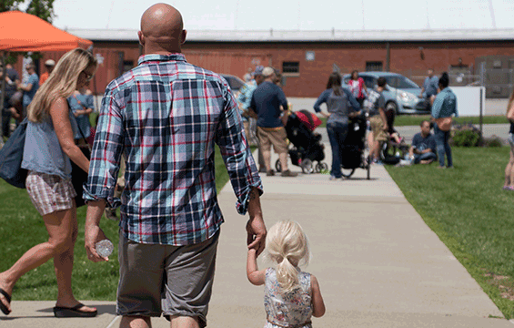 First Lt. Paul Stennett holds hands with his daughter during Family Day.