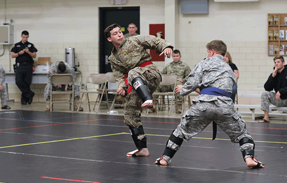 Spc. Anthony Skulina of the 296th Engineer Detachment prepares to kick his opponent, 1st Lt. Isaac Bray.