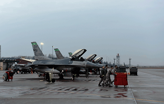 Crew chiefs assigned to the 180th Fighter Wing head out to prepare F-16 Fighting Falcons.