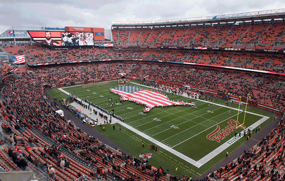 Ariel view of Browns stadium featuring ONG display of American flag in shape of united states.