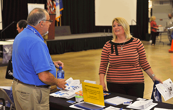 Rod Zeigler (left), membership coordinator for Sam’s Club, explains the services they offer government employees and service members to Beverly Sherwin.