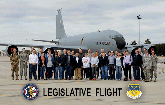 State legislators and staff members stand for a group photo in front of a KC-135R Statotanker.
