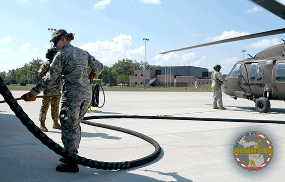 Airman with hose fueling aircraft.
