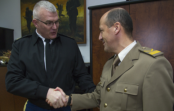 Shepherd and Milakovic shaking hands/exchanging coin.
