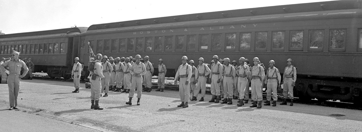 Soldiers from Battery B, 137th AAA Bn. stand in formation after getting off of a Boston and Albany train at Camp Perry. 