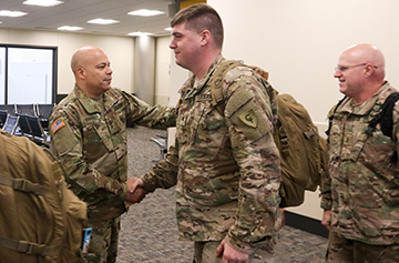 Maj. Gen. John C. Harris Jr. (left), Ohio assistant adjutant general for Army, welcomes home members of the Ohio Army National Guard’s 1st Battalion, 137th Aviation Regiment.