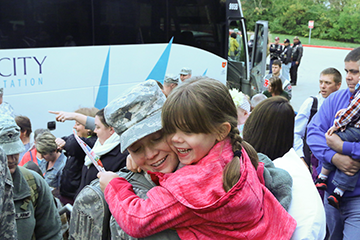 Soldiers of the 1st Battalion, 174th Air Defense Artillery Regiment are greeted by their Families and friends before a welcome home ceremony.