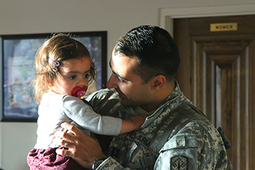 Soldiers of the 1st Battalion, 174th Air Defense Artillery Regiment are greeted by their Families and friends before a welcome home ceremony.