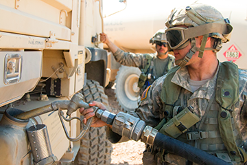 A Soldier with the 1st Battalion, 145th Armored Regiment refuels a M1078 Light Mobility Utility Truck (LMTV) during maintenance operations.