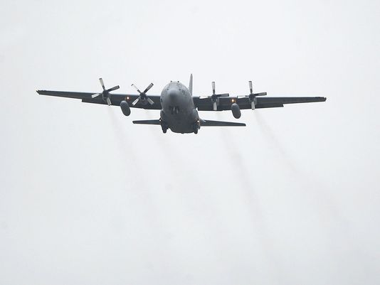 A C-130 passes over the base before landing.
