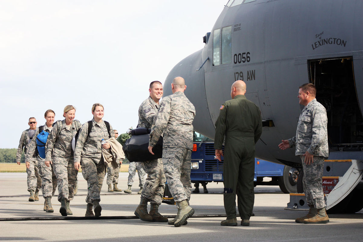 Airmen greet pilot before boarding a C-130H Hercules aircraft