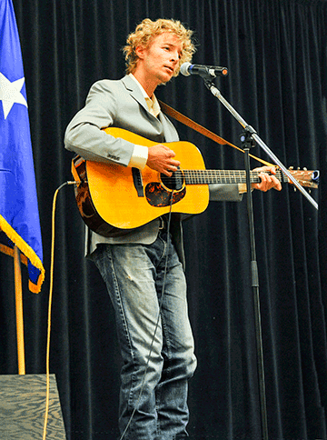 Columbus singer-songwriter Barefoot McCoy performing with guitar.