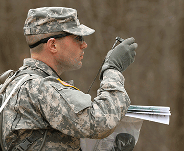 Spc. Preston Layne, representing the 174th Air Defense Artillery Brigade, checks his point during a land navigation course.