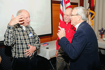 Retired Maj. Phil Ring (from left) and retired Cols. Gary Bowman and Raymond Applegate share stories.