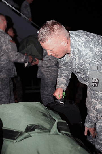 Sgt. Joshua Gerhart, a satellite communication systems operations noncommissioned officer attached to the 137th Signal Company, unloads gear from a KC-135 Stratotanker.