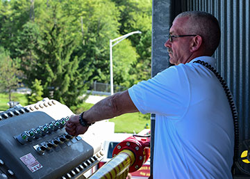 Richard A. Hare, the assistant chief for the 910th Airlift Wing Fire Department, turns on a burner from control panel.