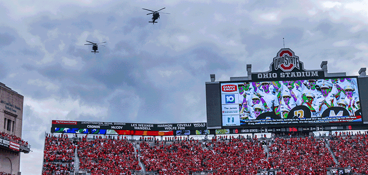 Two Ohio Army National Guard UH-60M Black Hawk helicopters fly over Ohio Stadium before the Ohio State-Army game.