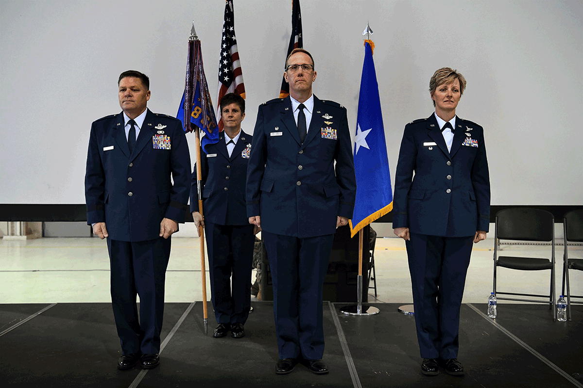 Commanders in formation on stage.