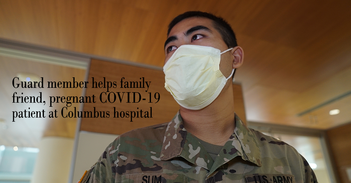 Head shot of Pfc. Dal Sum with mask in hospital lobby.