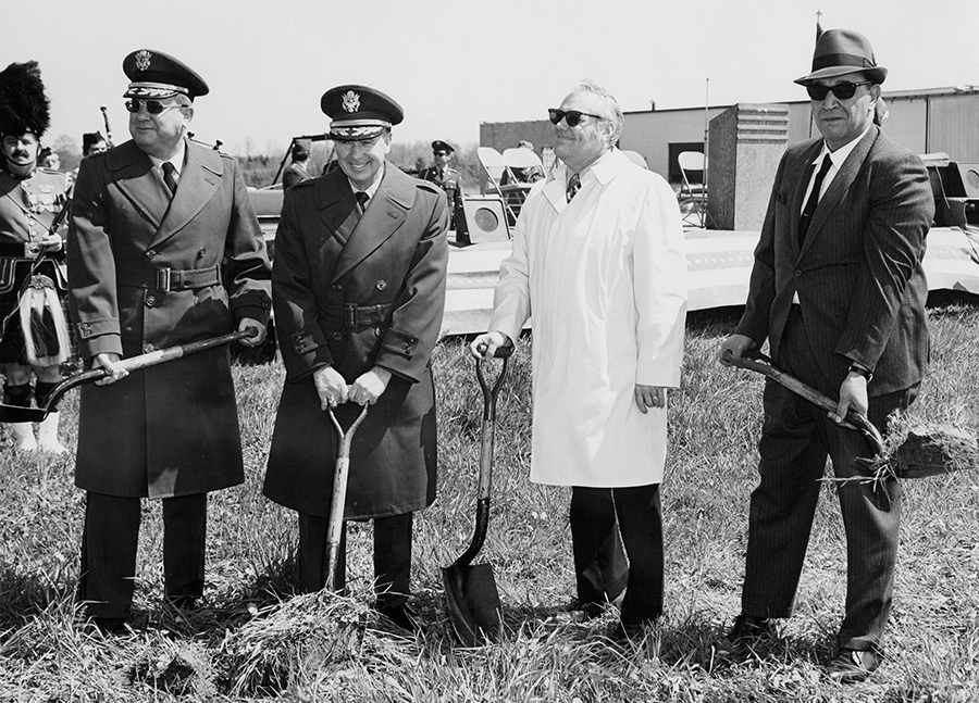 Men stand for photo at ground breaking.