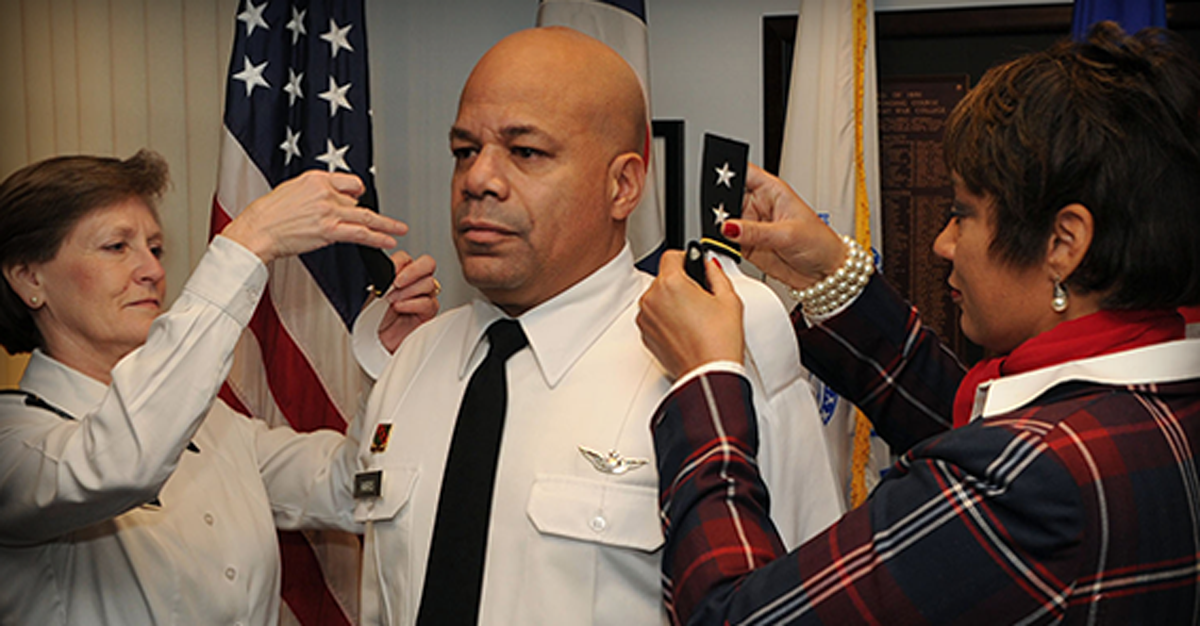 Maj. Gen. John C. Harris Jr. receives his new shoulder rank epaulettes.