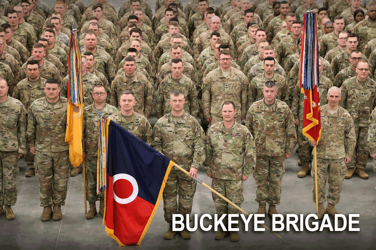 Soldiers stand in formation behind commanders changing of colors.