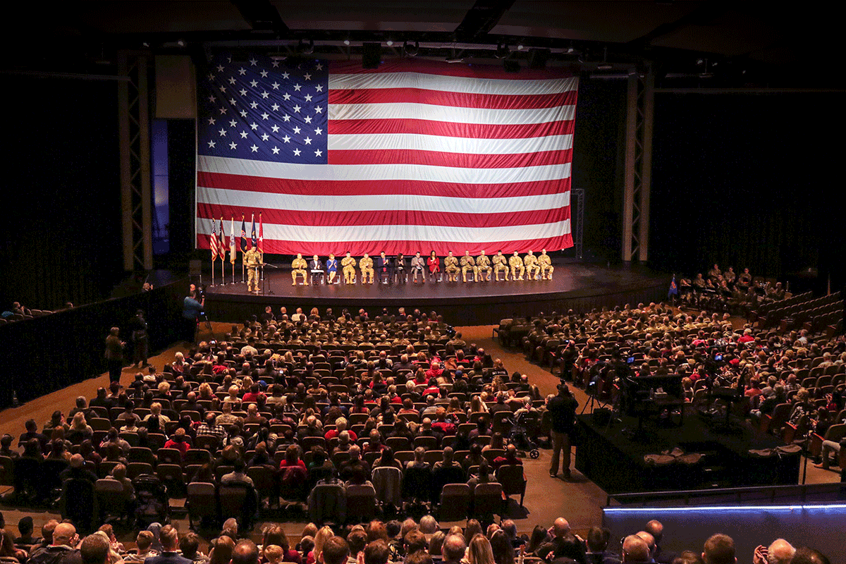 Stage with American flag backdrop as seen from back of the auditorium.