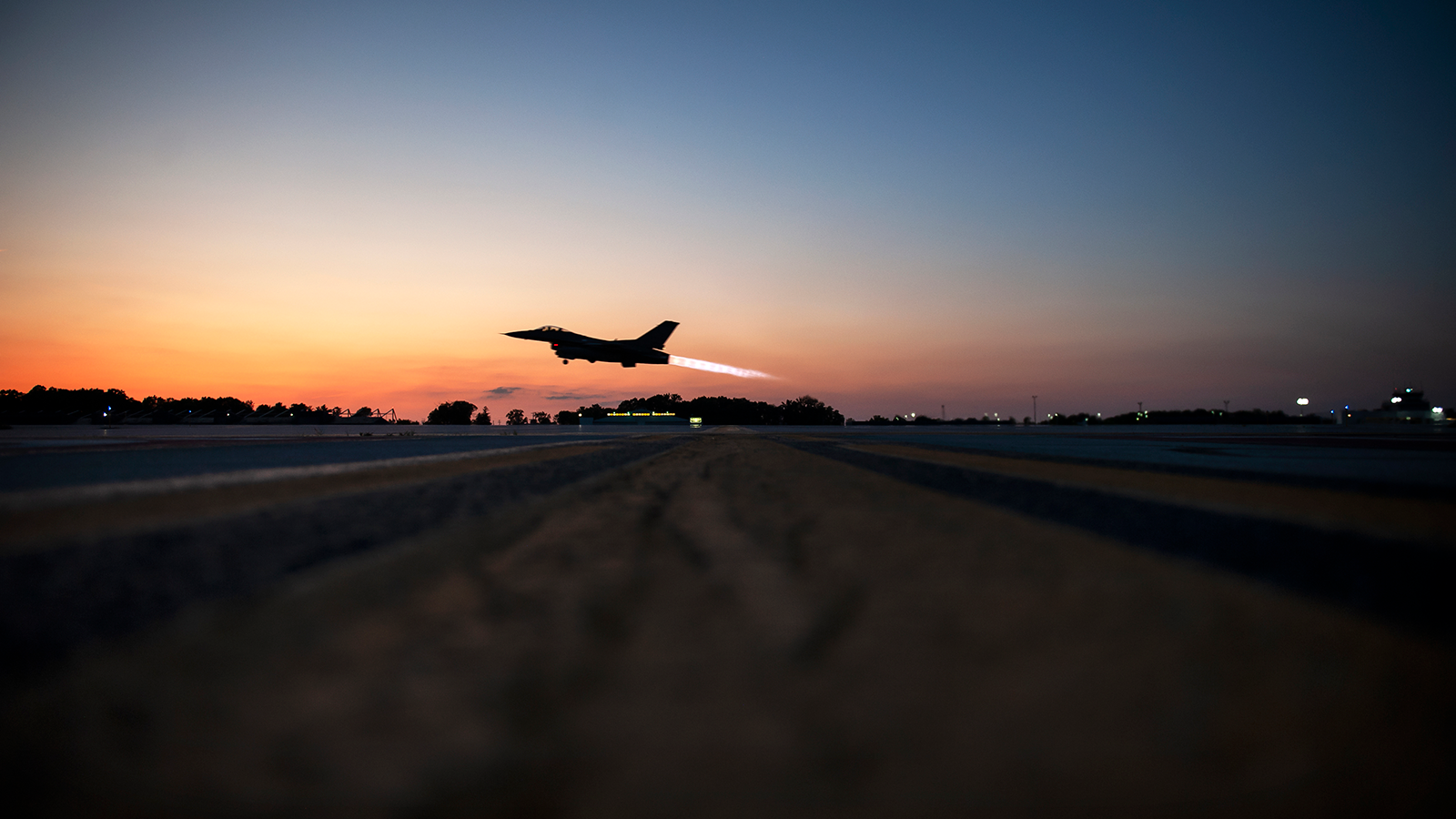 F-16 Fighting Falcon taking off at sunset.. 