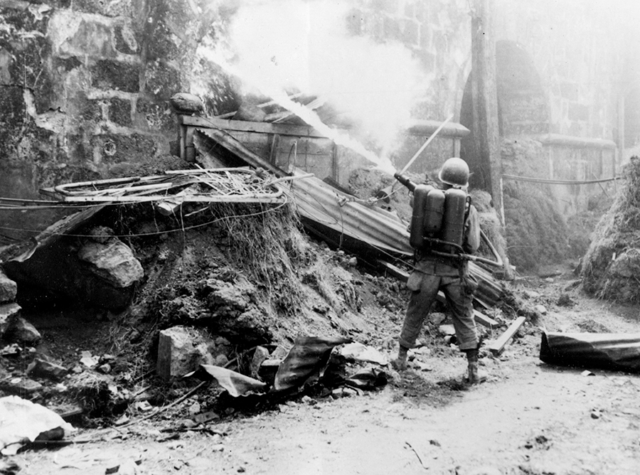 A 37th Infantry Division Soldier uses a flame thrower on a Japanese position during the battle for the walled city of Intramuros, Manila, Philippine Islands in late February 1945.