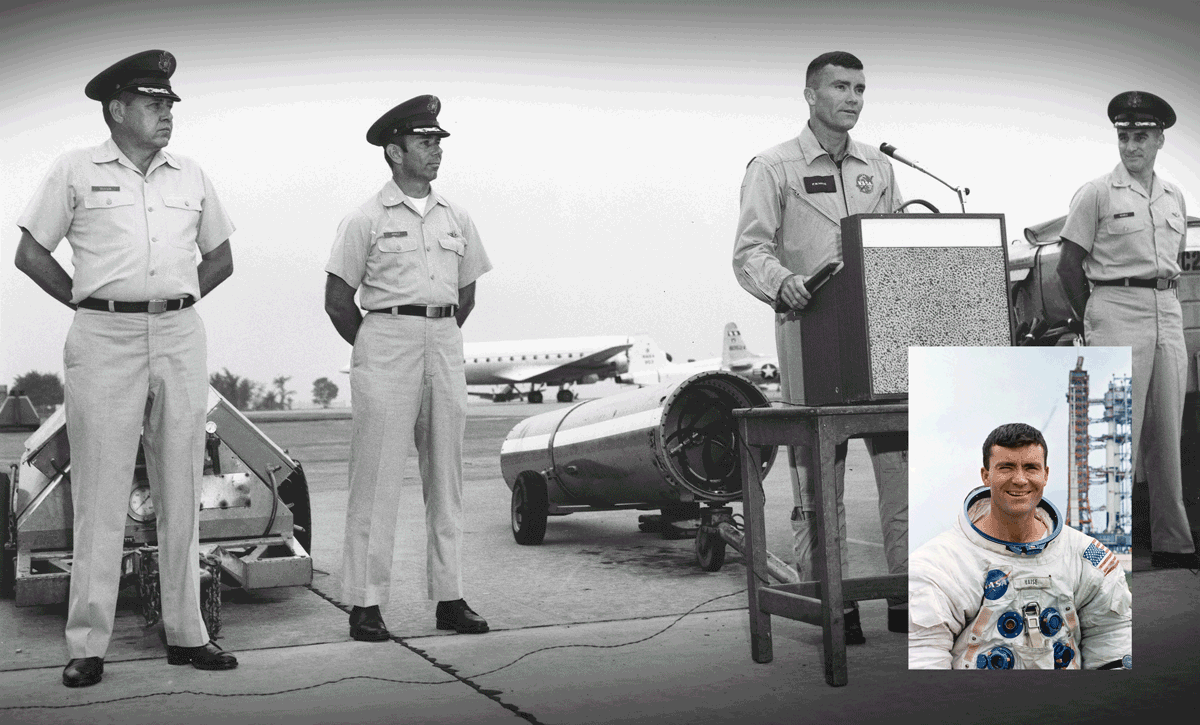 Black and white photo of Haise at lectern on tarmak at airforce base with officers on either side of him with inset of him in astronaut gear.