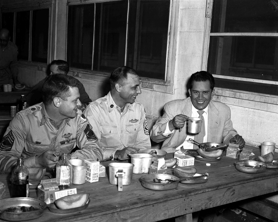 Tech. Sgt. Cleto Rodriquez eating with fellow soldiers