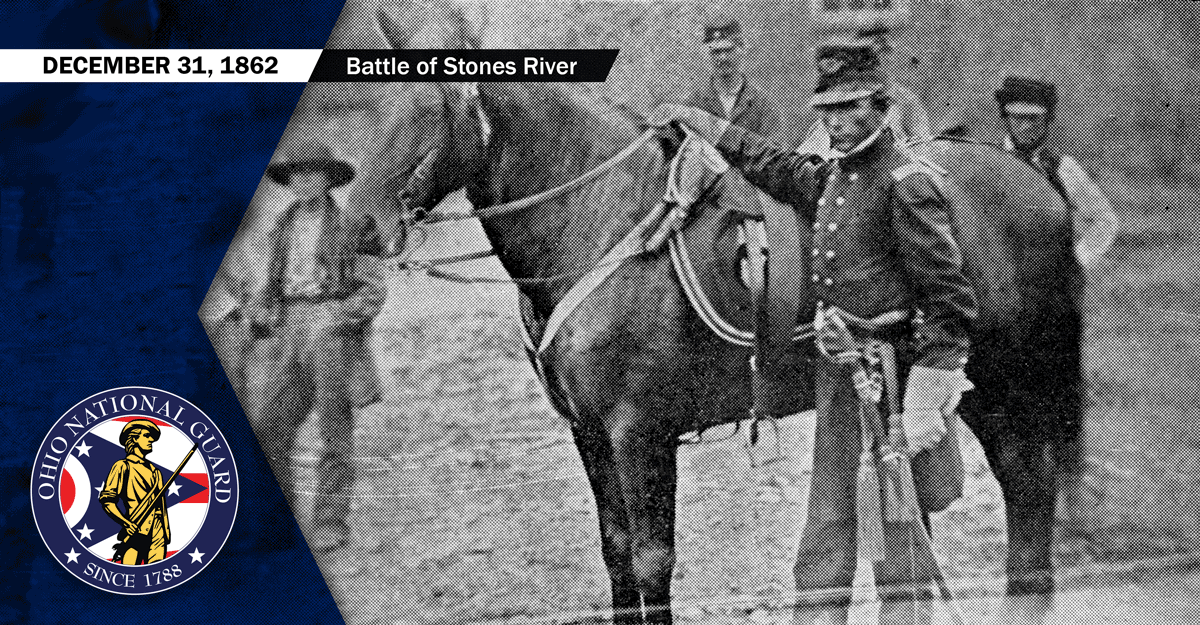 Black and white photo of  Soldier in uniform standing by horse.