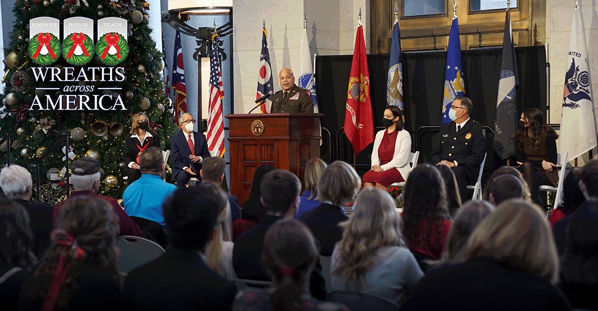 Leadership in front of Christmas tree, Maj. Gen. Harris at podium.