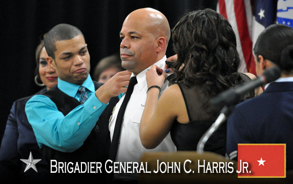 Brig. General John C. Harris, Jr. is pinned by his son and daughter.